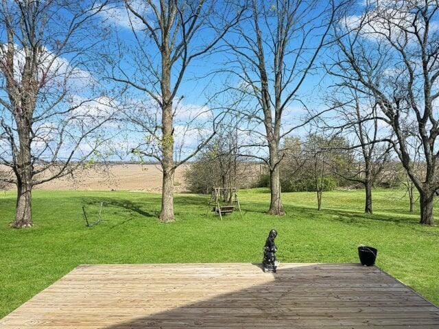 wooden deck featuring a lawn
