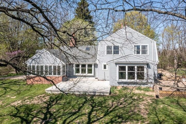 back of property featuring a yard and a patio