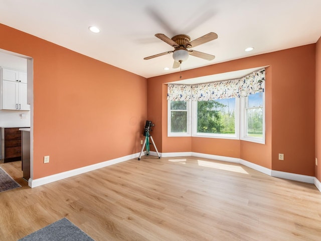 empty room with light wood-style floors, baseboards, ceiling fan, and recessed lighting