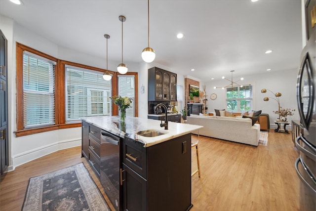 618 Berkeley Rd, Columbus, OH 43205 - kitchen featuring a sink, wine cooler, a kitchen island with sink, fridge, and light wood-style floors