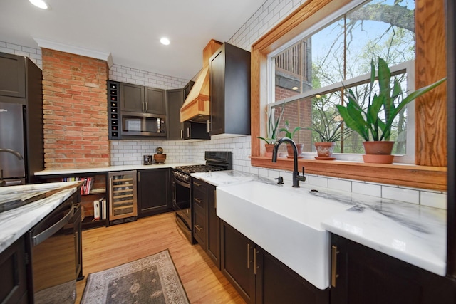 618 Berkeley Rd, Columbus, OH 43205 - kitchen with appliances with stainless steel finishes, beverage cooler, tasteful backsplash, custom exhaust hood, and recessed lighting