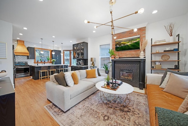 618 Berkeley Rd, Columbus, OH 43205 - living room with light wood-type flooring, a tiled fireplace, and recessed lighting