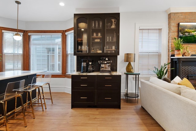 618 Berkeley Rd, Columbus, OH 43205 - bar area with light wood finished floors, baseboards, recessed lighting, and pendant lighting