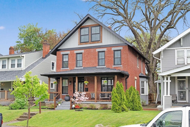 618 Berkeley Rd, Columbus, OH 43205 - view of front of house with brick siding, a porch, a front lawn, and board and batten siding