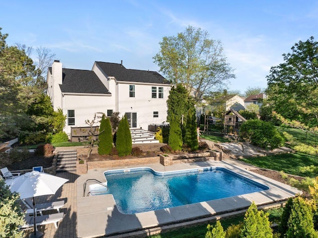 pool featuring fence and a patio area