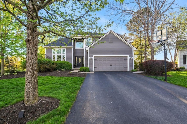 traditional home with an attached garage, driveway, and a front lawn