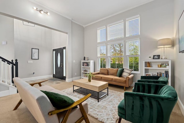 living room with stairs, a high ceiling, ornamental molding, and baseboards
