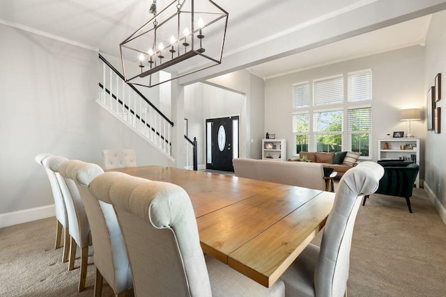 dining area with carpet flooring, crown molding, an inviting chandelier, stairs, and baseboards