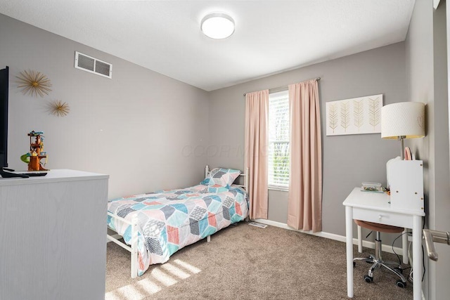 carpeted bedroom with baseboards and visible vents