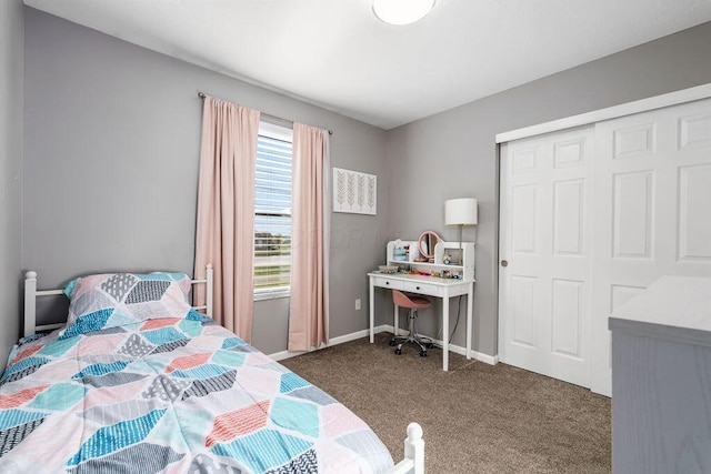 carpeted bedroom with a closet and baseboards