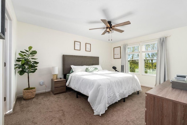 bedroom with baseboards, a ceiling fan, and carpet