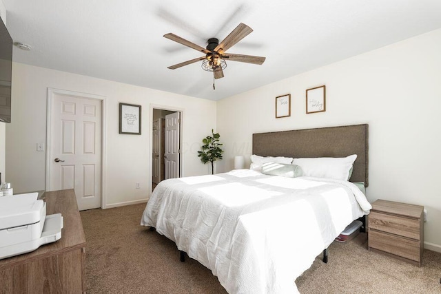 bedroom featuring baseboards, ceiling fan, and carpet