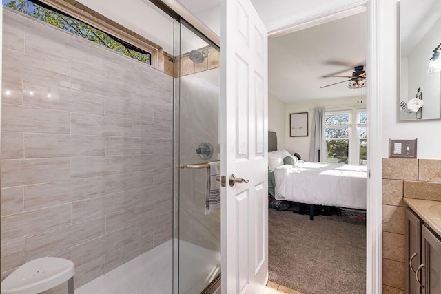 full bathroom with vanity, ceiling fan, a shower stall, and ensuite bath