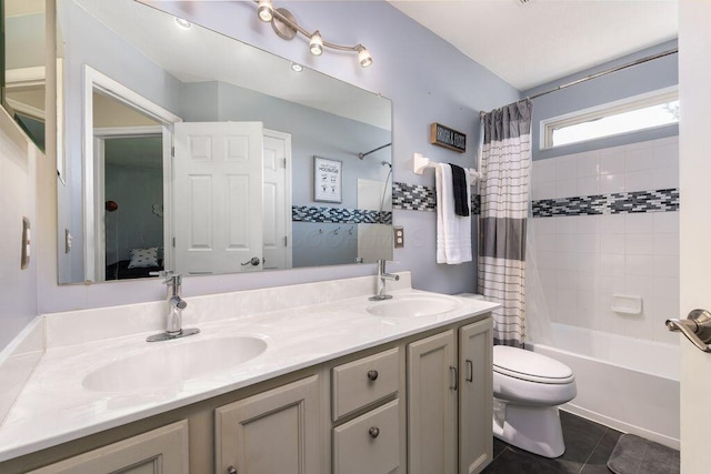 bathroom with a sink, toilet, double vanity, and shower / bath combination with curtain