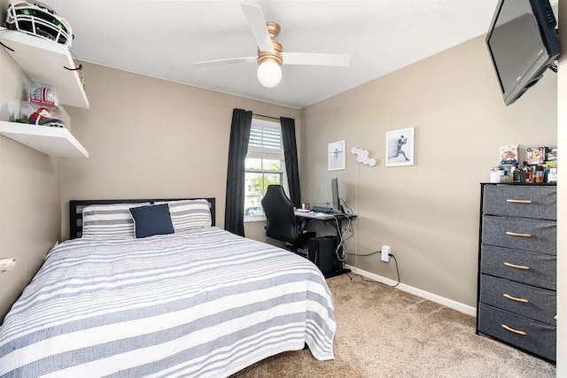 bedroom with a ceiling fan, baseboards, and light colored carpet