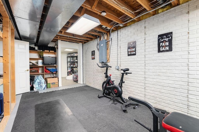 workout room with brick wall and electric panel