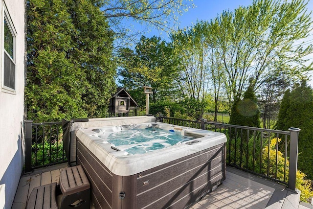 wooden deck featuring a hot tub