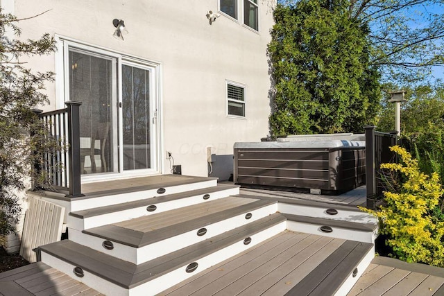 wooden deck with a hot tub