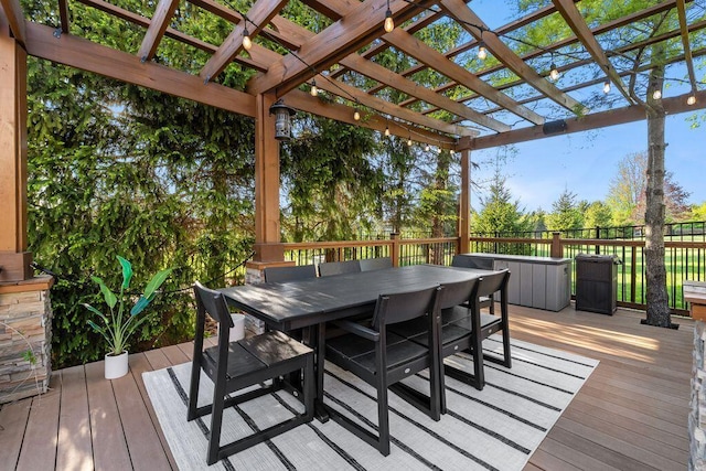 wooden terrace with a pergola and outdoor dining area