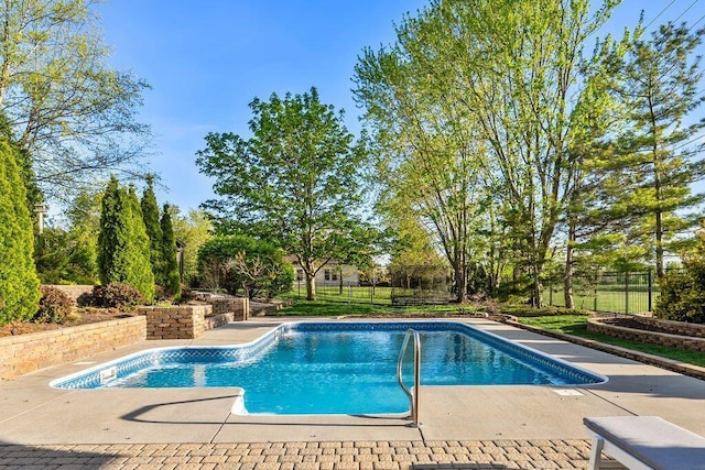 view of swimming pool with a patio, a fenced in pool, and a fenced backyard