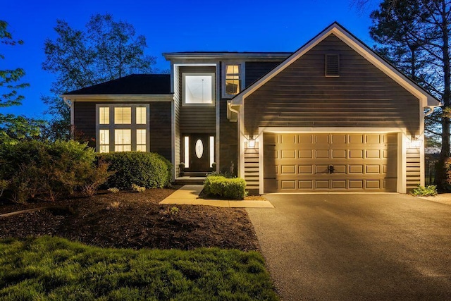 traditional-style home with an attached garage and driveway
