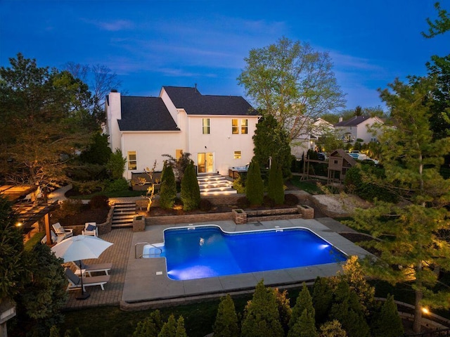 pool featuring a patio area and stairway