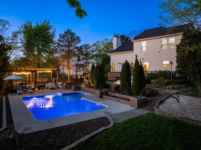 pool featuring a patio, outdoor lounge area, and fence