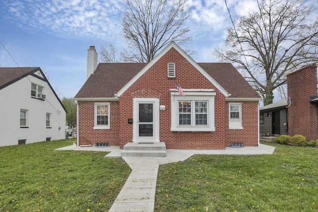 603 S James Rd, Columbus, OH 43213 - english style home with roof with shingles, a chimney, a front lawn, and brick siding