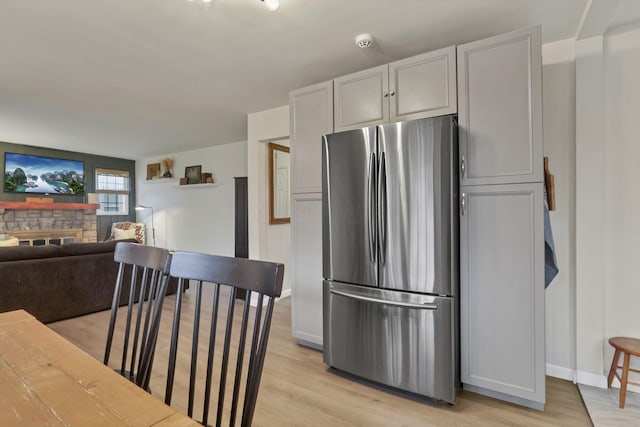 603 S James Rd, Columbus, OH 43213 - kitchen with freestanding refrigerator, baseboards, open floor plan, and light wood finished floors