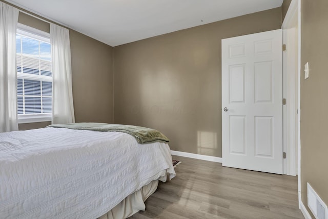 603 S James Rd, Columbus, OH 43213 - bedroom featuring baseboards, wood finished floors, and visible vents