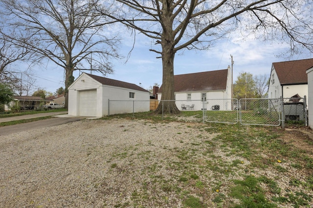 603 S James Rd, Columbus, OH 43213 - view of yard with driveway, an outbuilding, a gate, a detached garage, and fence