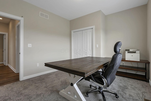 office space with visible vents, carpet, and baseboards