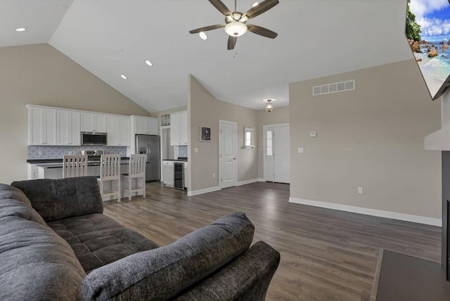 living room with high vaulted ceiling, a ceiling fan, dark wood-type flooring, and visible vents