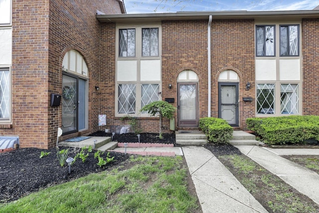 townhome / multi-family property with brick siding