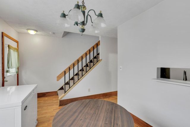 stairway with baseboards and wood finished floors