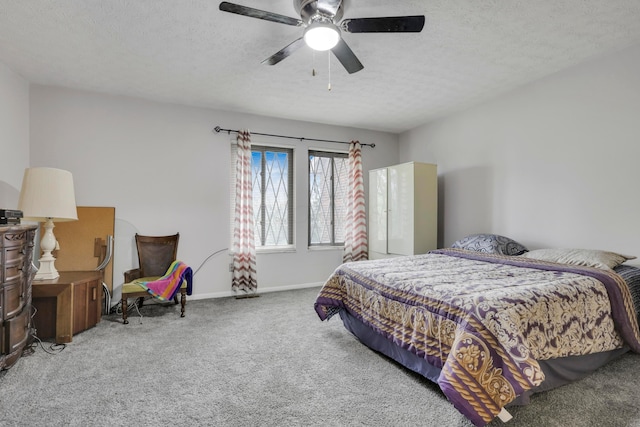 carpeted bedroom featuring baseboards, a ceiling fan, and a textured ceiling