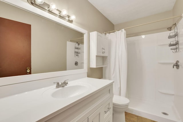 bathroom with vanity, a shower with shower curtain, tile patterned flooring, and toilet