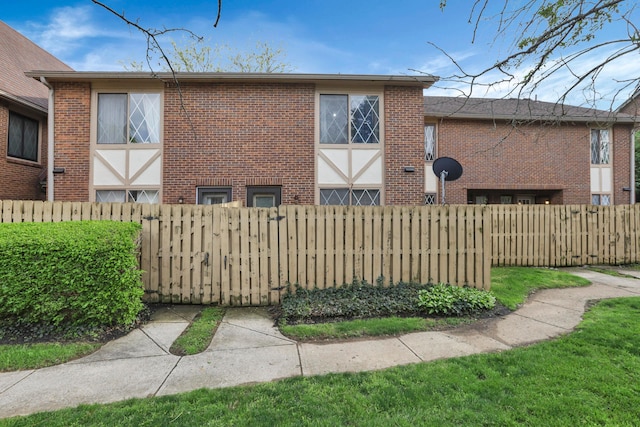view of side of property featuring brick siding and fence private yard