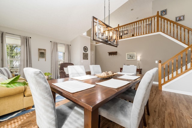 dining area featuring stairway, wood finished floors, and a healthy amount of sunlight