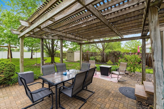 view of patio with outdoor dining area, an outbuilding, a fenced backyard, a storage unit, and a pergola