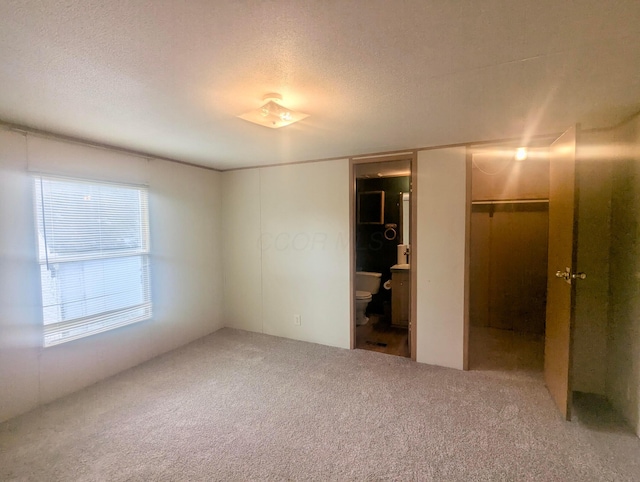 200 Ann St, New Straitsville, OH 43766 - unfurnished bedroom featuring carpet floors, a textured ceiling, and a closet
