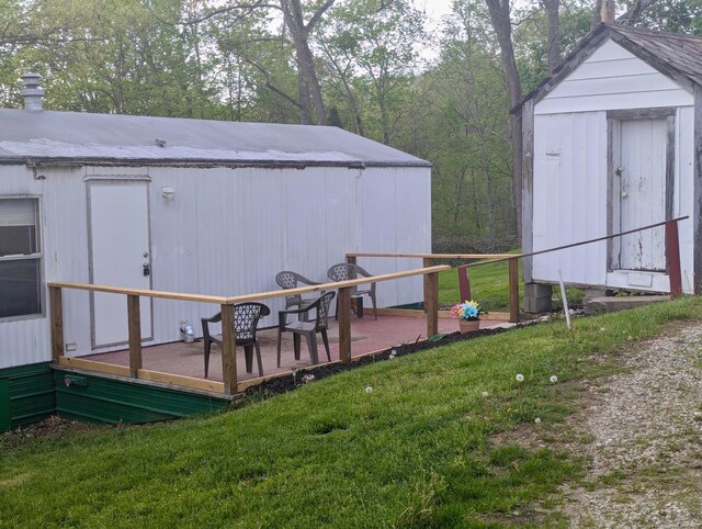 200 Ann St, New Straitsville, OH 43766 - view of green lawn with an outdoor structure, a shed, and a wooden deck