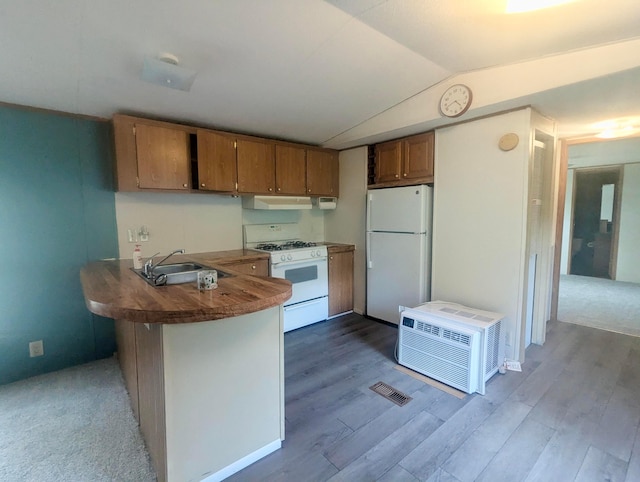 200 Ann St, New Straitsville, OH 43766 - kitchen featuring white appliances, a sink, brown cabinetry, a peninsula, and under cabinet range hood