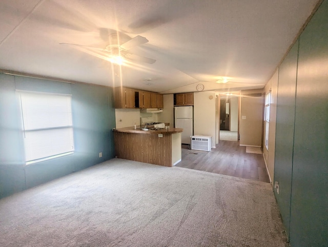200 Ann St, New Straitsville, OH 43766 - kitchen featuring freestanding refrigerator, open floor plan, carpet floors, a peninsula, and lofted ceiling