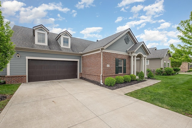 view of front of home featuring driveway, brick siding, a front lawn, an attached garage, and a shingled roof