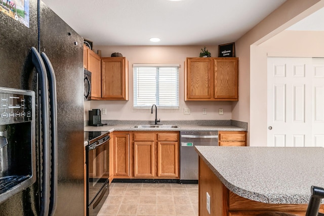 kitchen with light tile patterned flooring, a sink, light countertops, recessed lighting, and black appliances