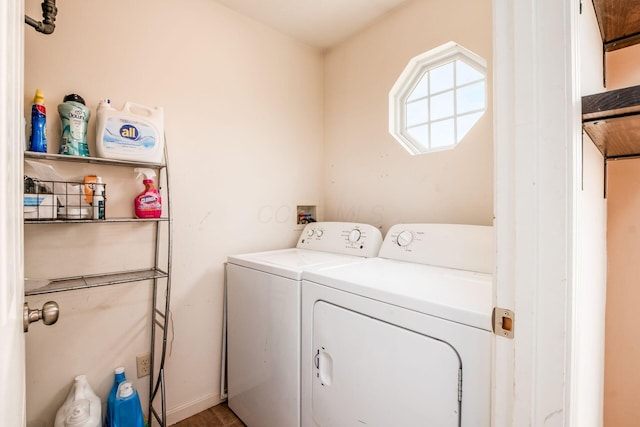 laundry room with laundry area, baseboards, and washing machine and clothes dryer