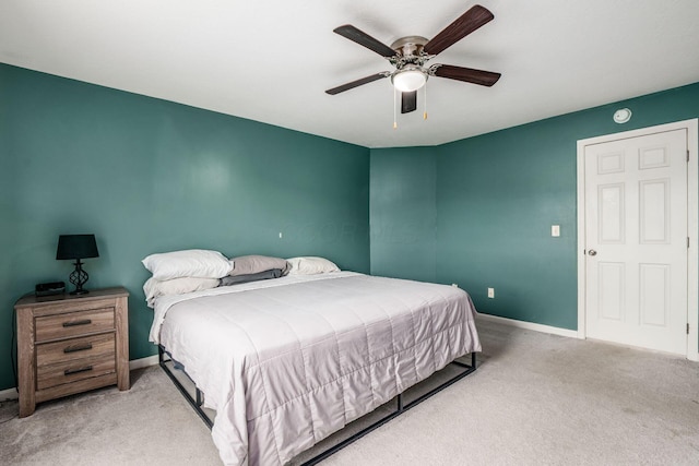 carpeted bedroom with baseboards and ceiling fan