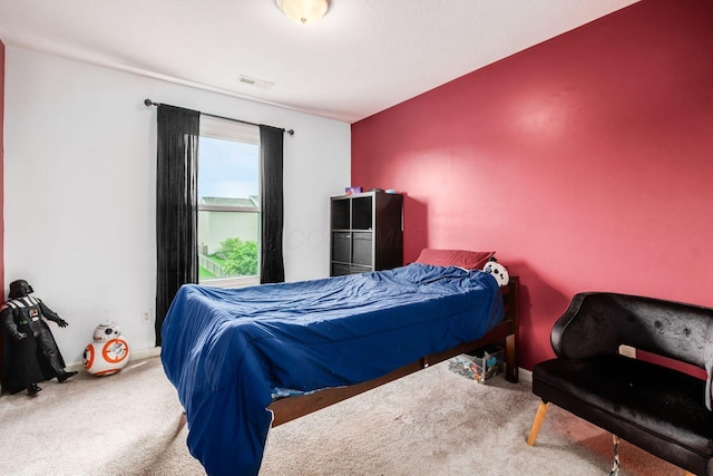 carpeted bedroom featuring visible vents