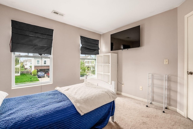 carpeted bedroom with visible vents and baseboards